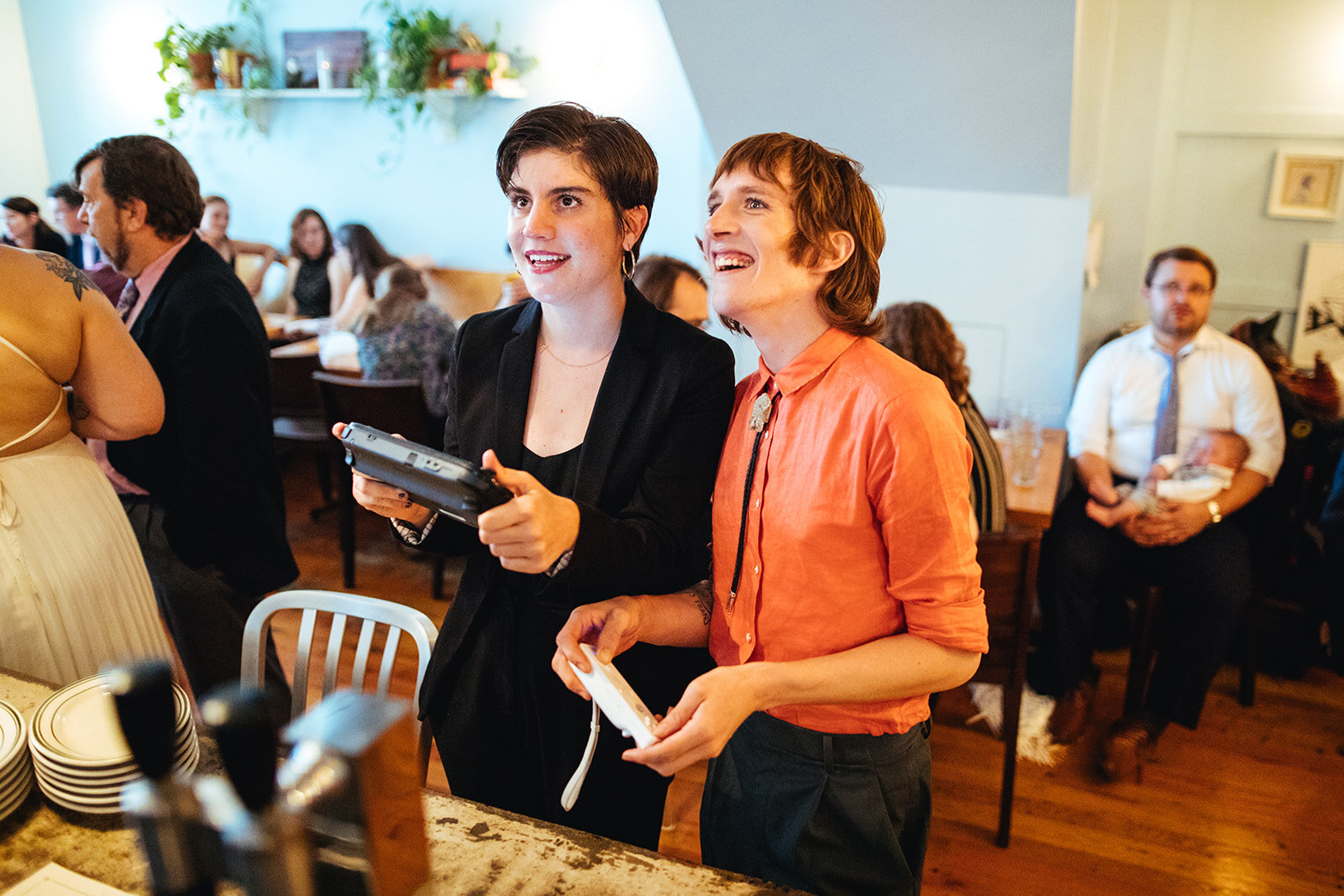 Guests playing video games at Philadelphia reception Shawnee Custalow Queer Wedding photography