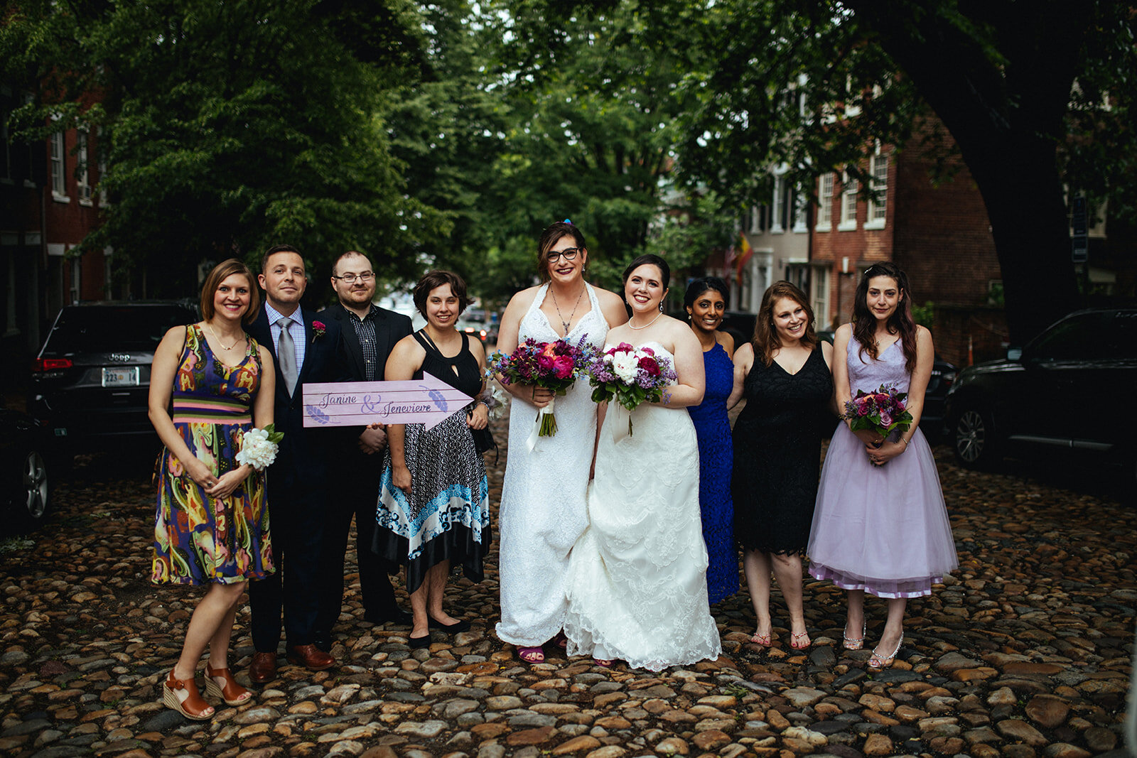 Newlywed brides posing with friends in Alexandria VA Shawnee Custalow Queer Wedding Photographer