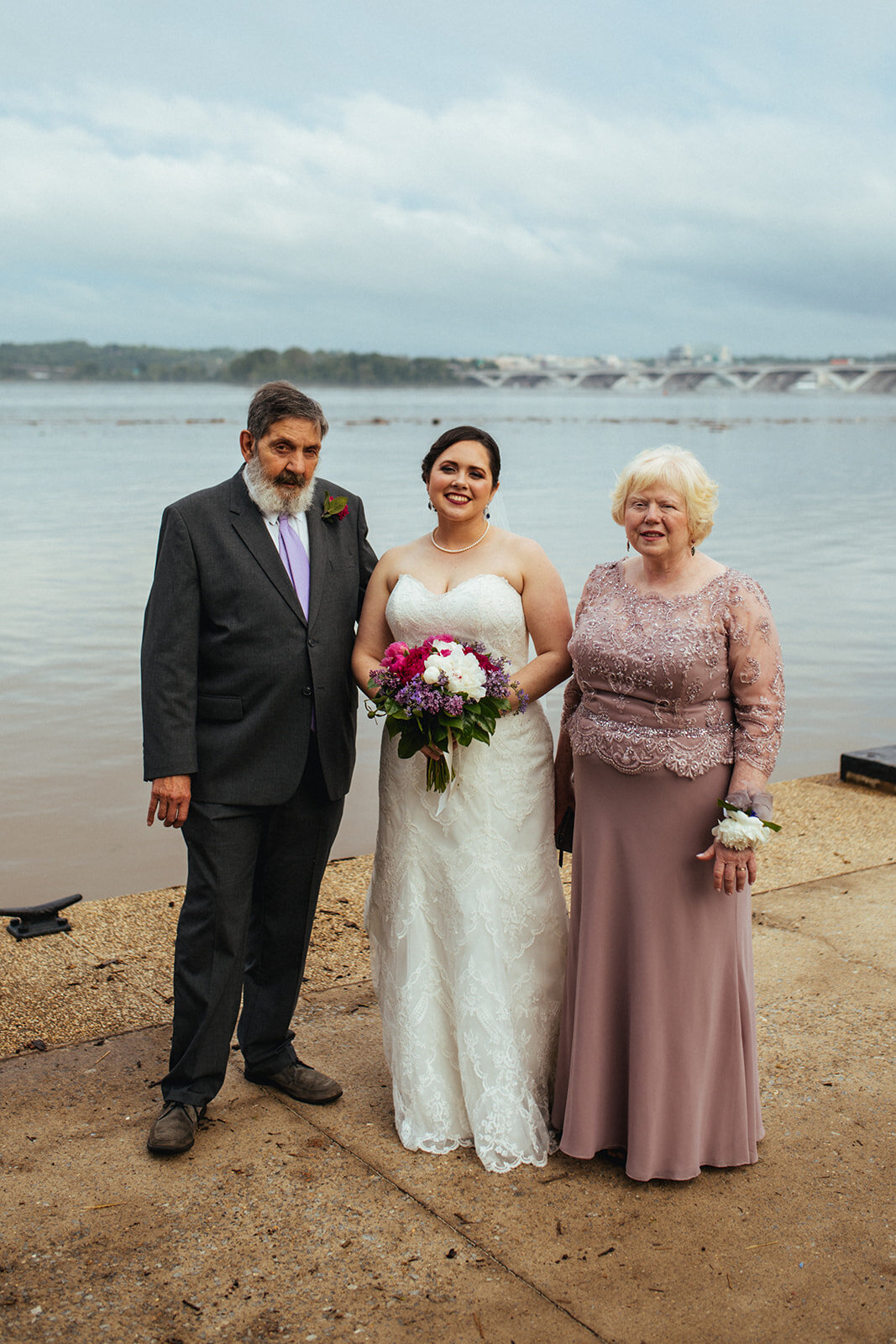 Newlywed bride posing with parents in Alexandria VA Shawnee Custalow Queer Wedding Photographer