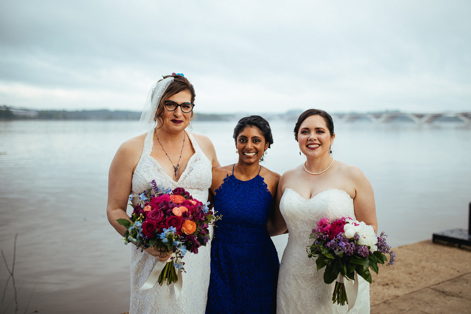 Newlywed brides posing with friend in Alexandria VA Shawnee Custalow Queer Wedding Photographer