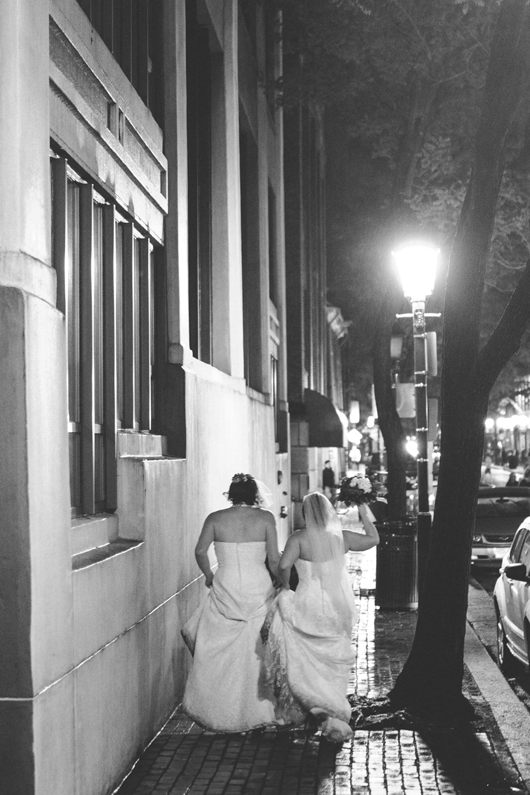 Newlyweds walking down the street in Alexandria VA Shawnee Custalow Queer Wedding photography