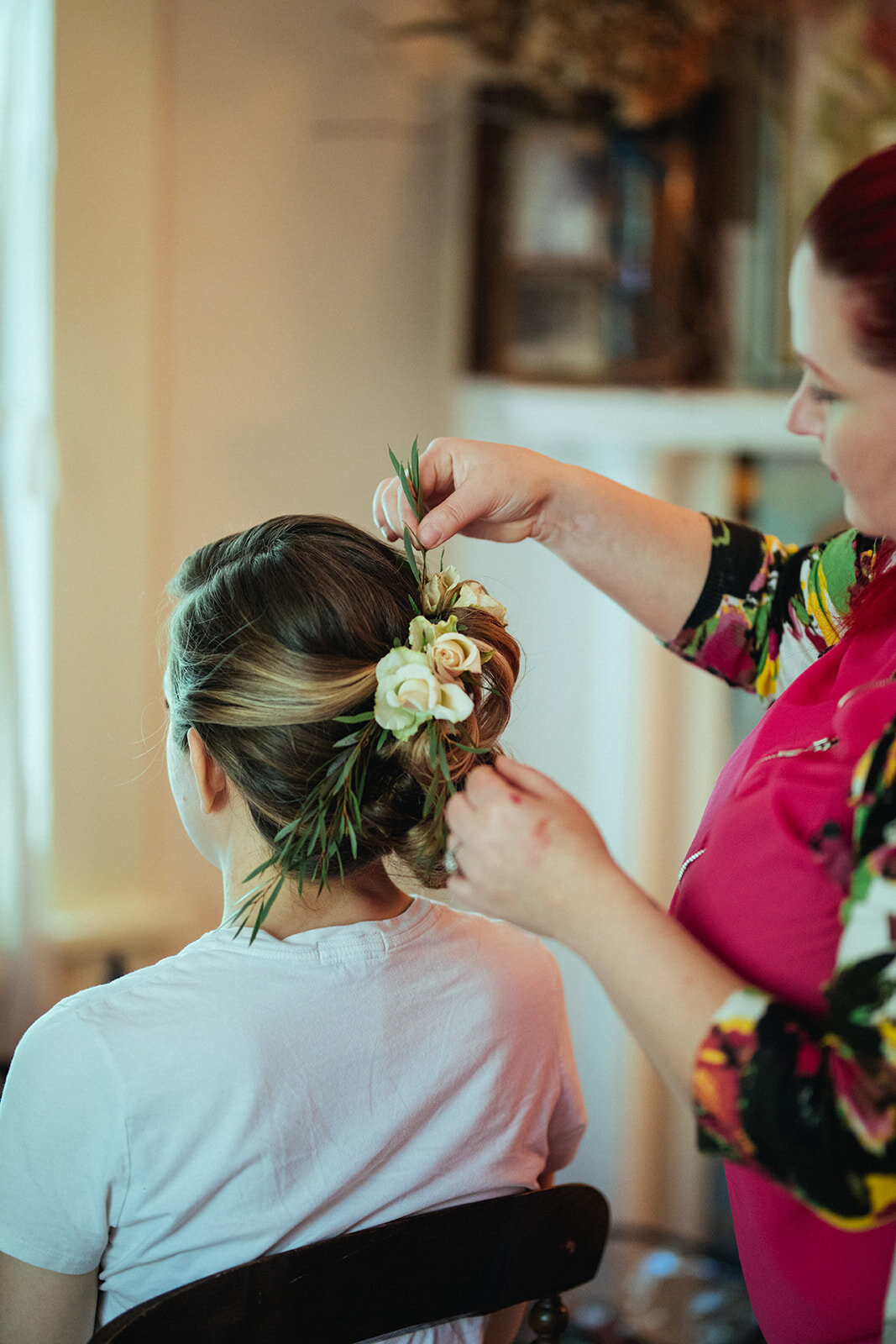 Bride getting a floral hair style in Atlanta Georgia Shawnee Custalow Queer Wedding Photographer