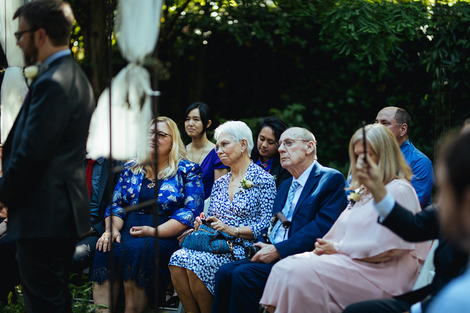 Guests watching a backyard wedding in Atlanta Ga Shawnee Custalow Queer Wedding Photographer