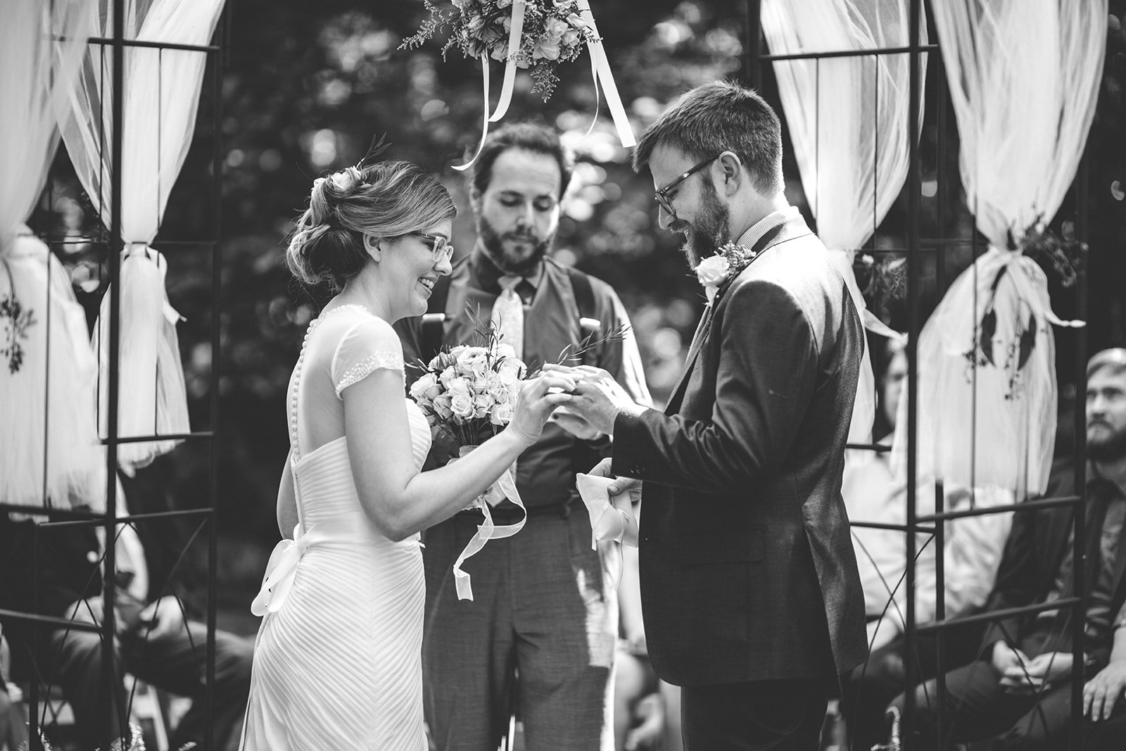 Bride and groom exchanging rings in backyard Atlanta Wedding Shawnee Custalow Photographer