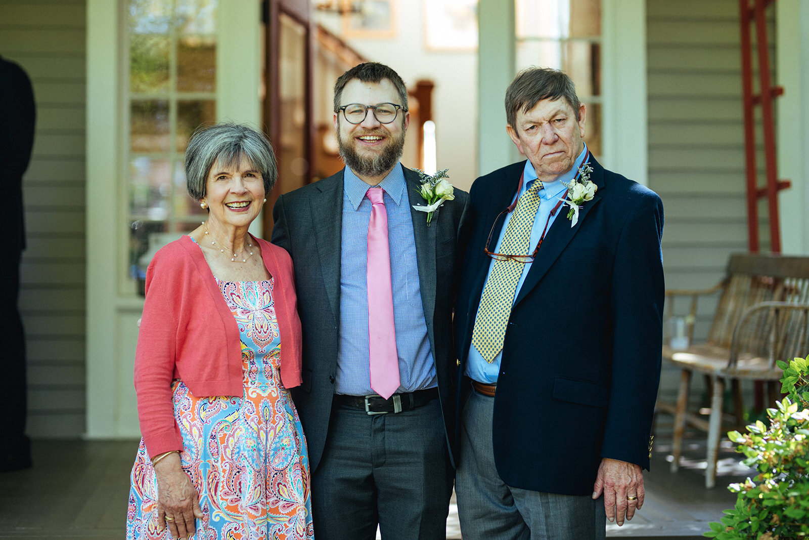 Groom posing with his parents at home in Atlanta GA Shawnee Custalow Queer Wedding Photographer