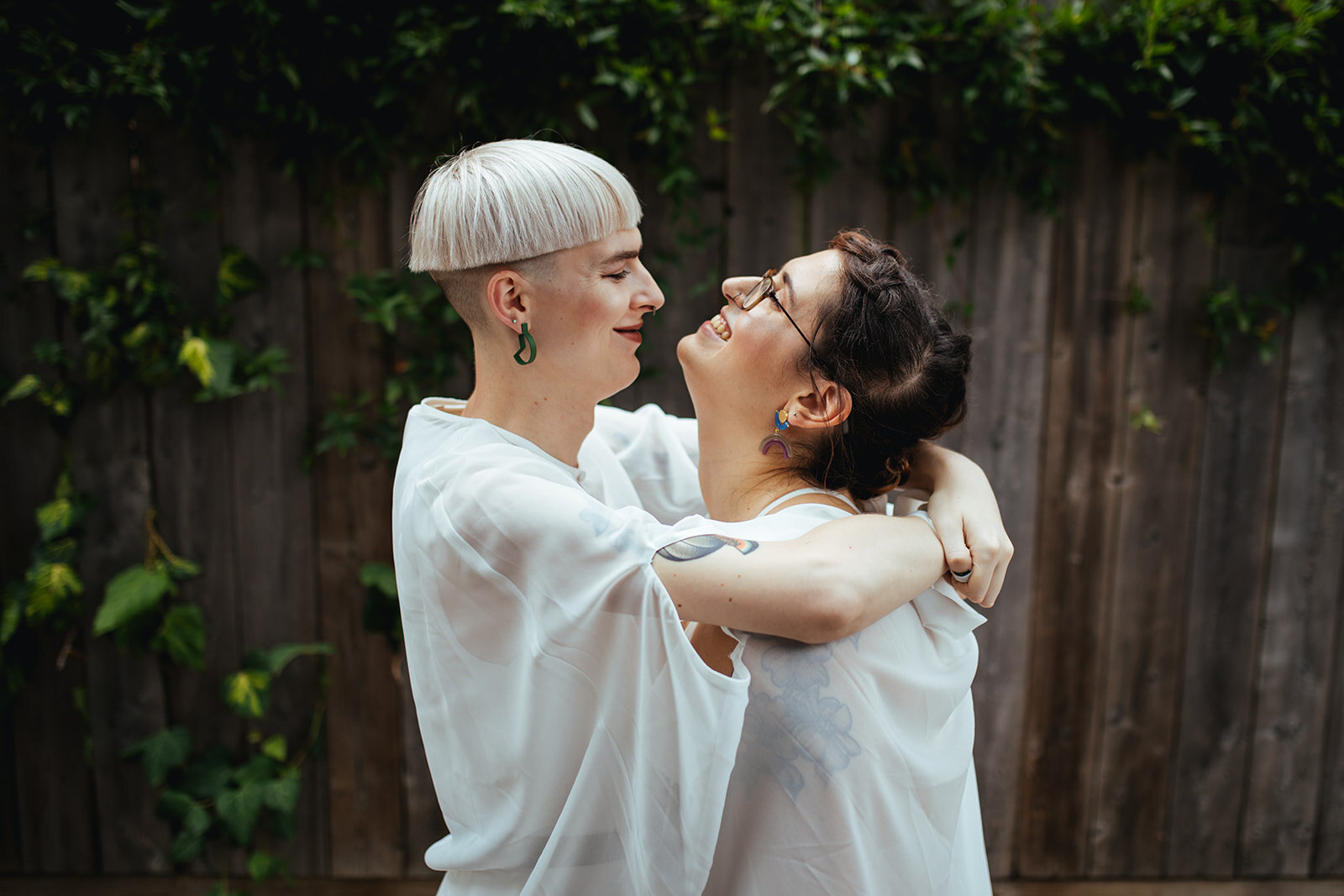 Happy newlyweds embracing outside in Philadelphia PA Shawnee Custalow Queer Wedding Photography