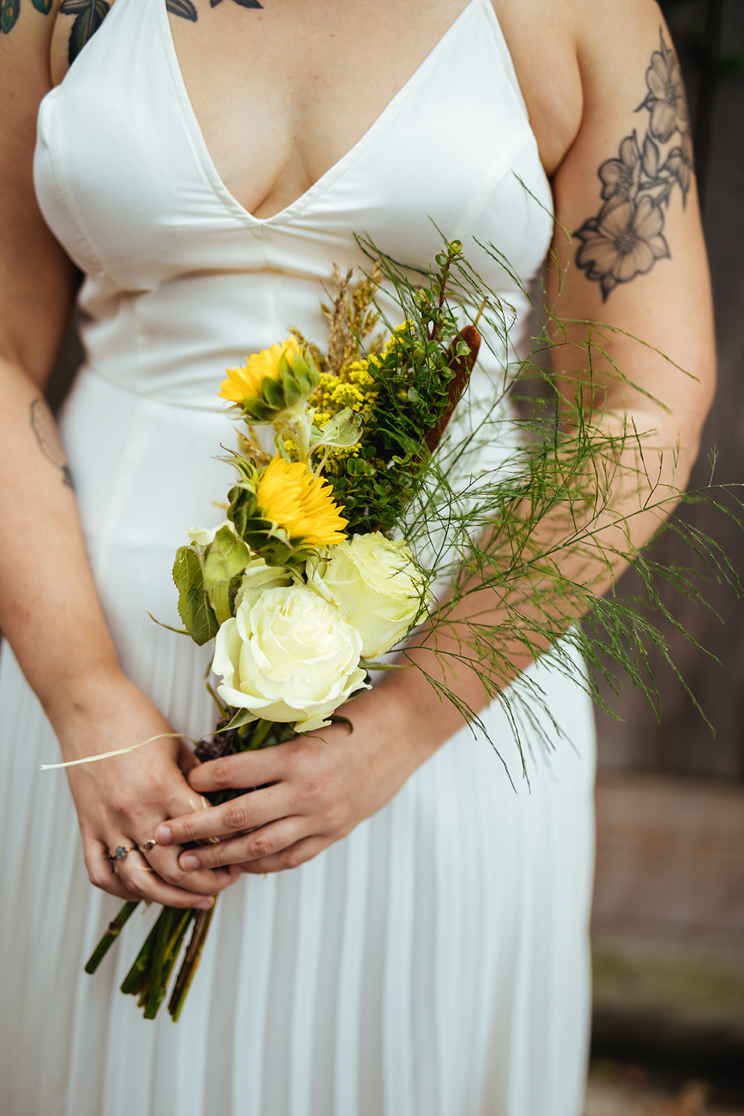 Yellow and white bouquet held by bride in Philly Shawnee Custalow Queer Wedding Photography