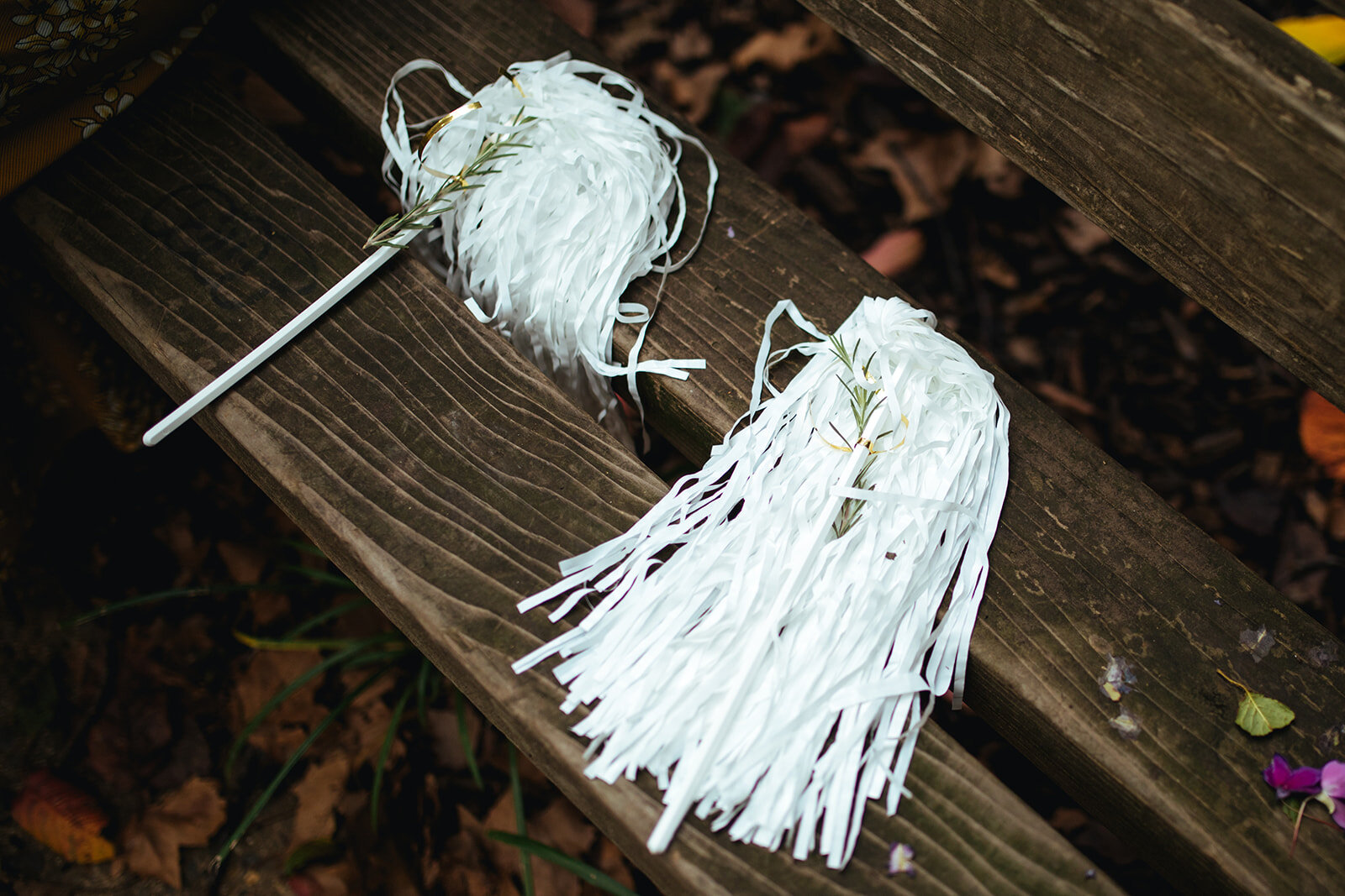 White pompoms with garlands on a bench in Philadelphia Shawnee Custalow Queer Wedding photography