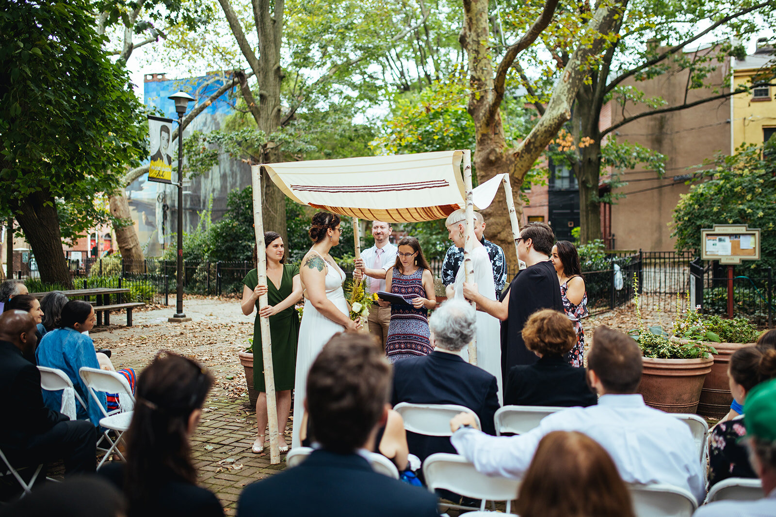 LGBTQ couple getting married under a chuppah outside in Philadelphia PA Shawnee Custalow Wedding Photography