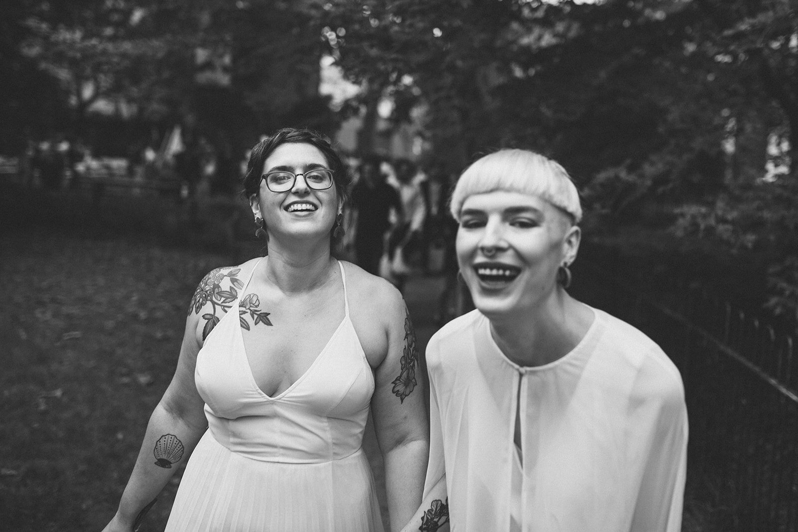 Happy LGBTQ newlyweds walking in Philadelphia Shawnee Custalow Queer Wedding photography