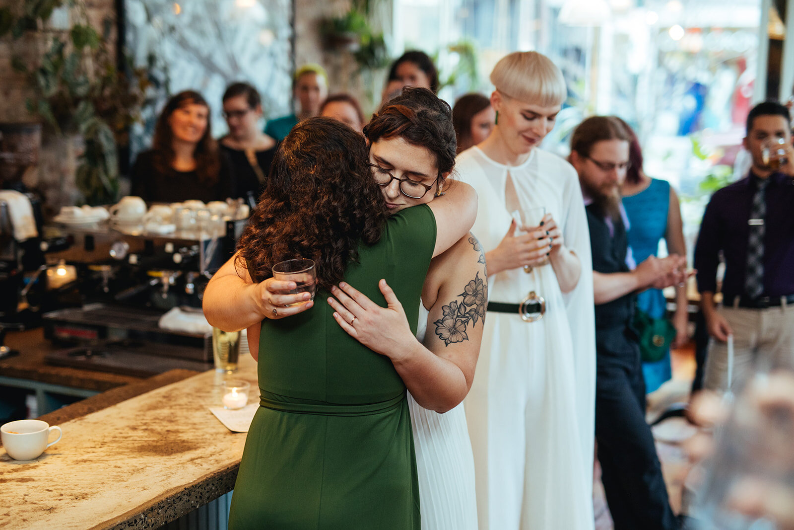 Newlywed hugging a guest at reception in Philadelphia Shawnee Custalow Queer Wedding photography