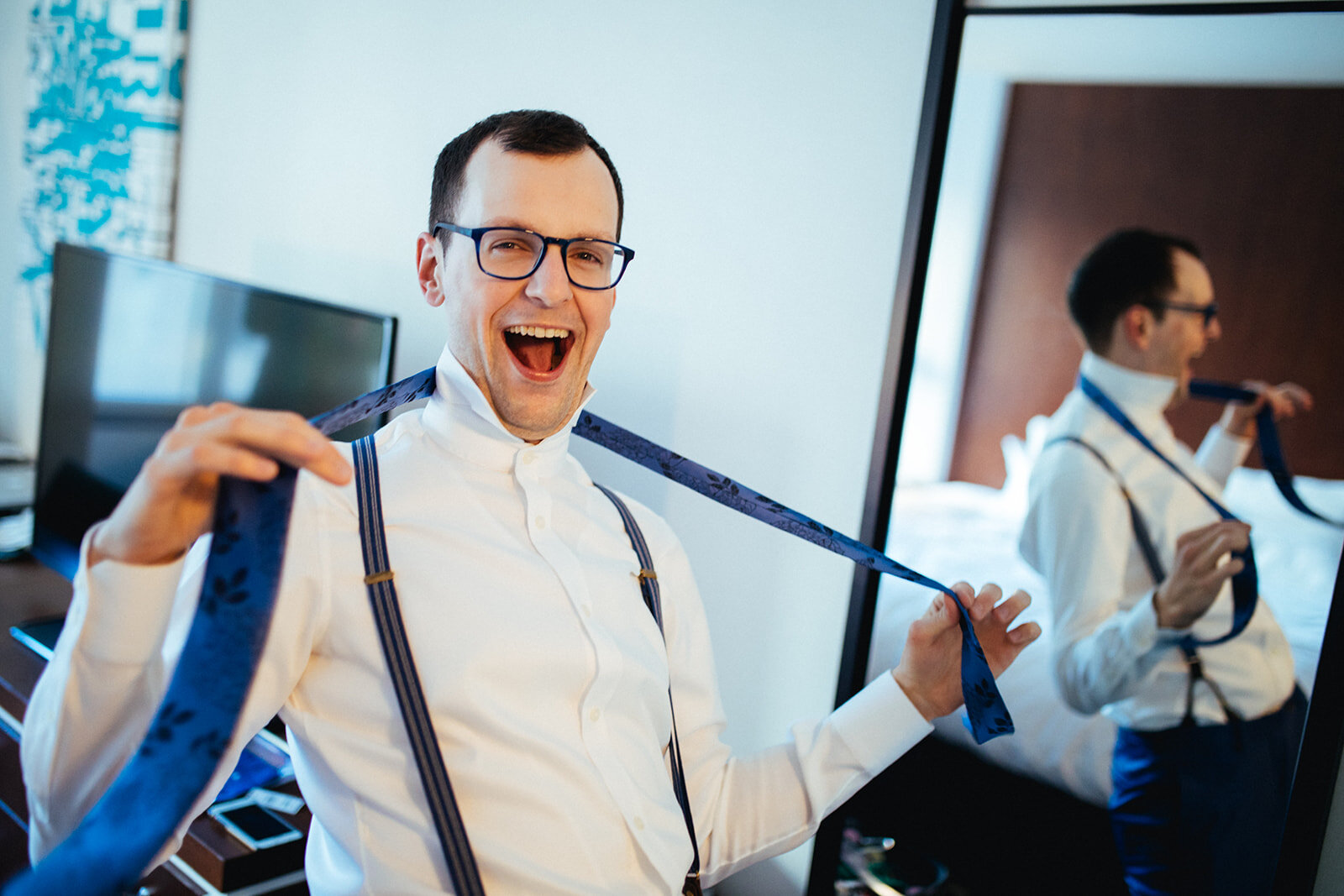Groom being silly with his tie in Brooklyn New York Shawnee Custalow queer wedding photographer