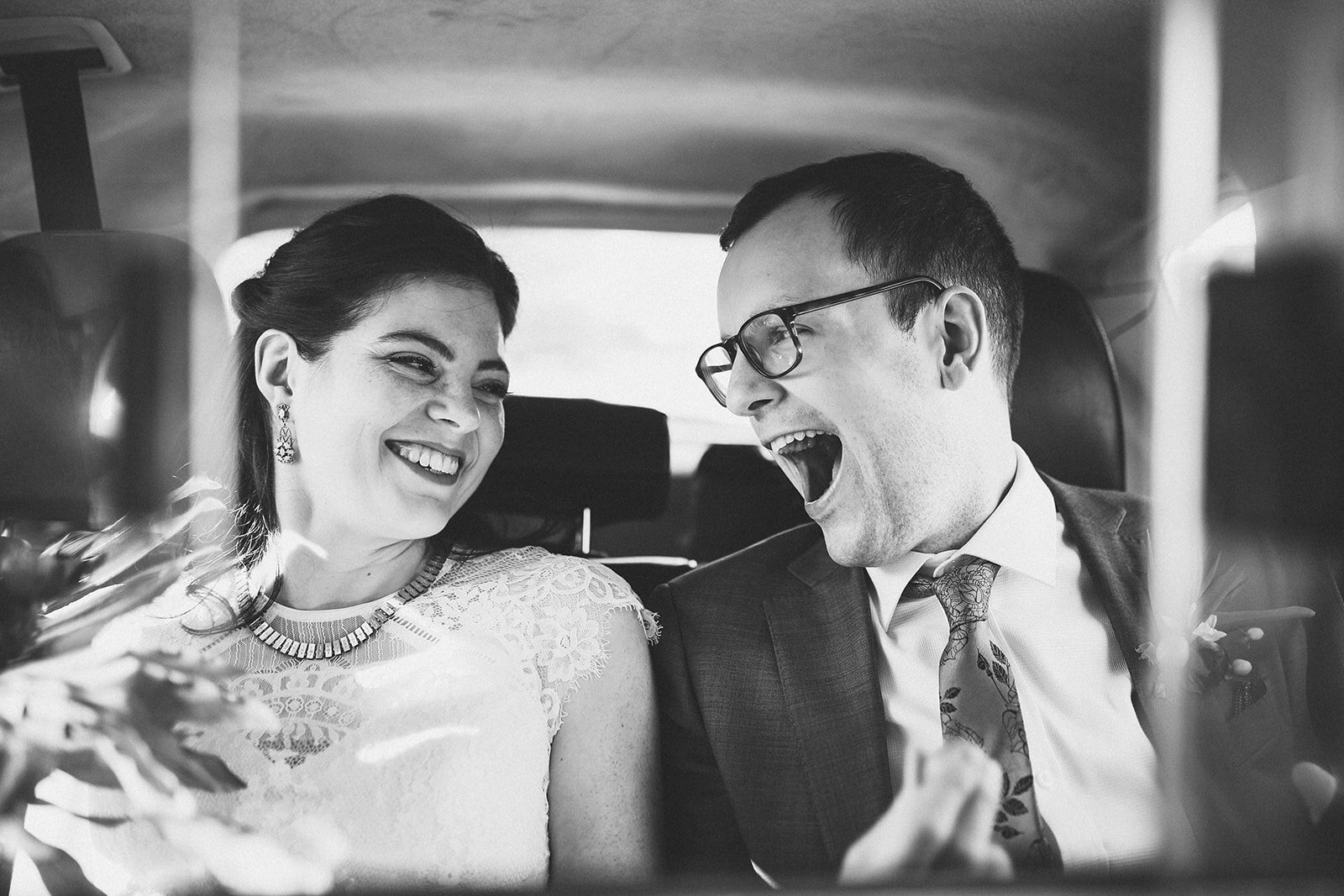 Bride and groom smiling together in a cab in New York Shawnee Custalow wedding photography