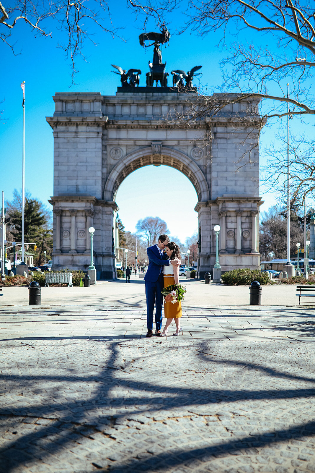 Bride and groom embracing by the Grand Army Plaza Arch NYC Shawnee Custalow wedding photography