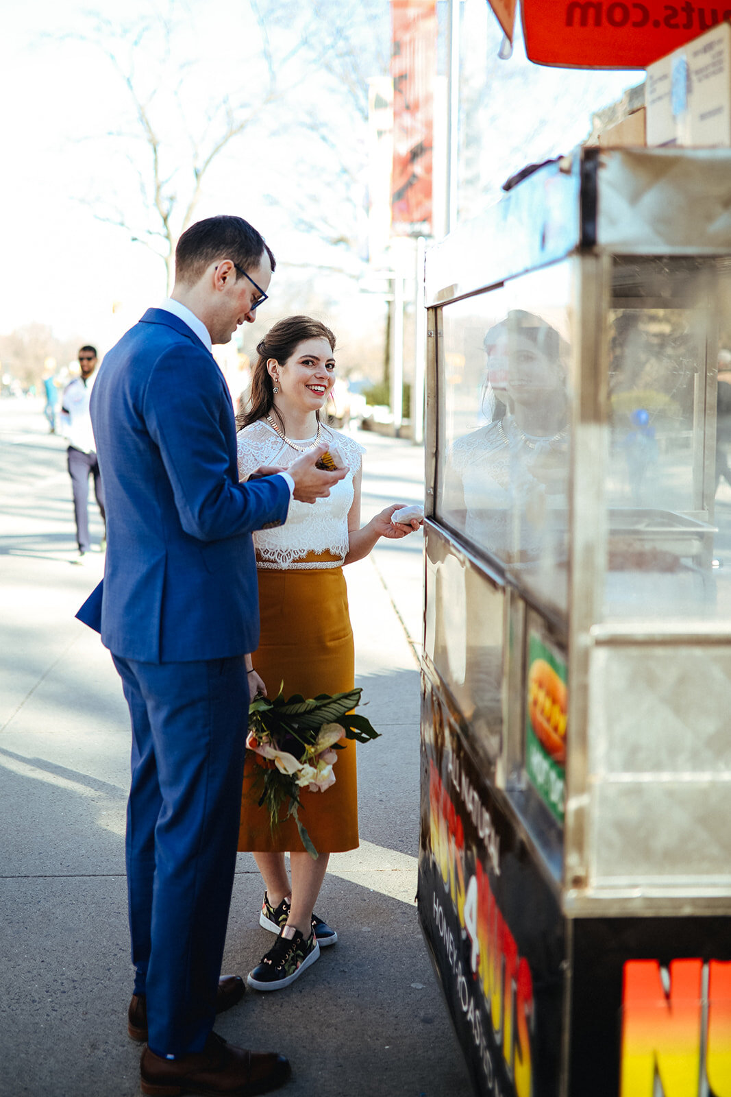 Future spouses purchases nuts from a street vendor in NYC Shawnee Custalow wedding photography