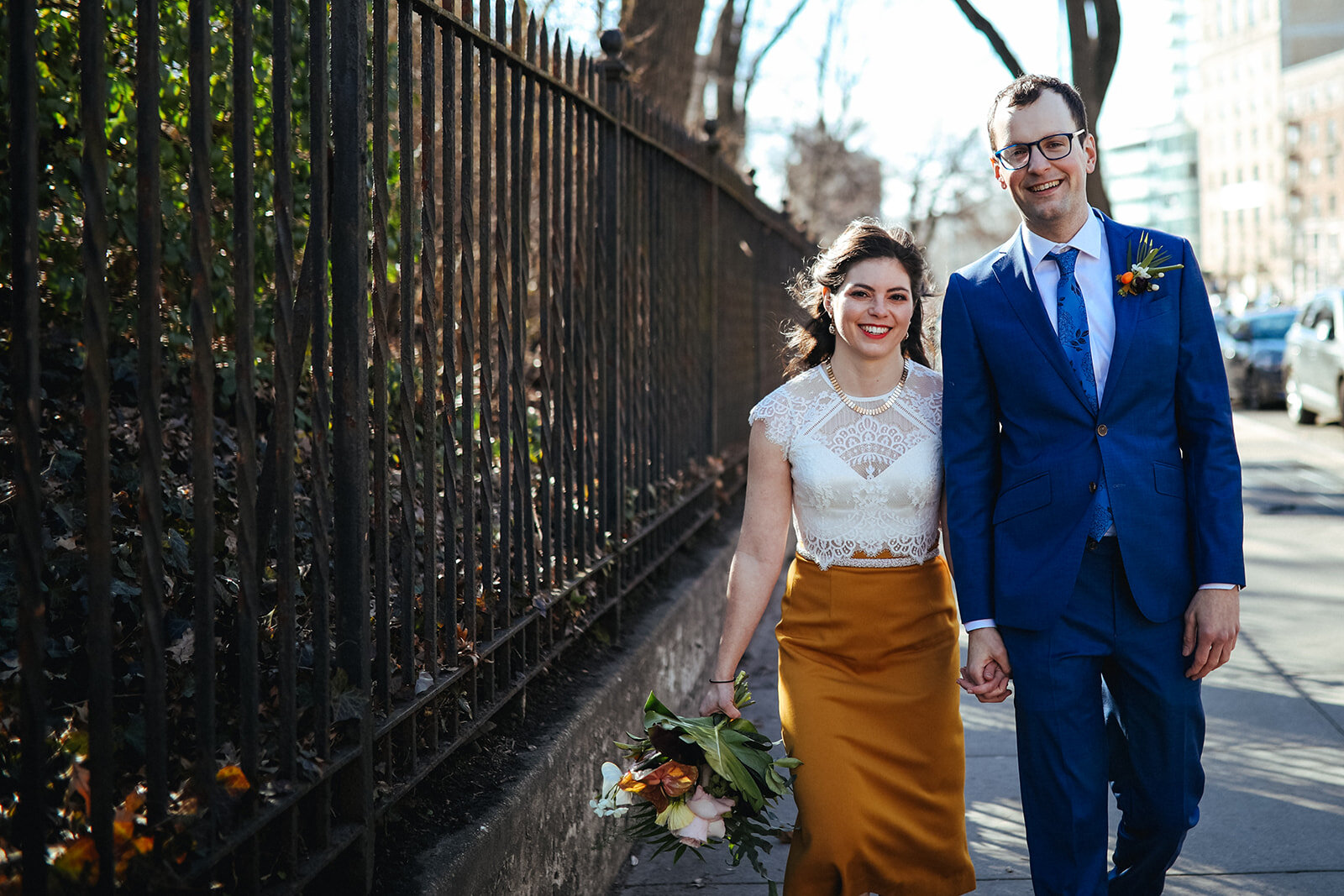 Future spouses walking hand in hand through New York City Shawnee Custalow queer wedding photography