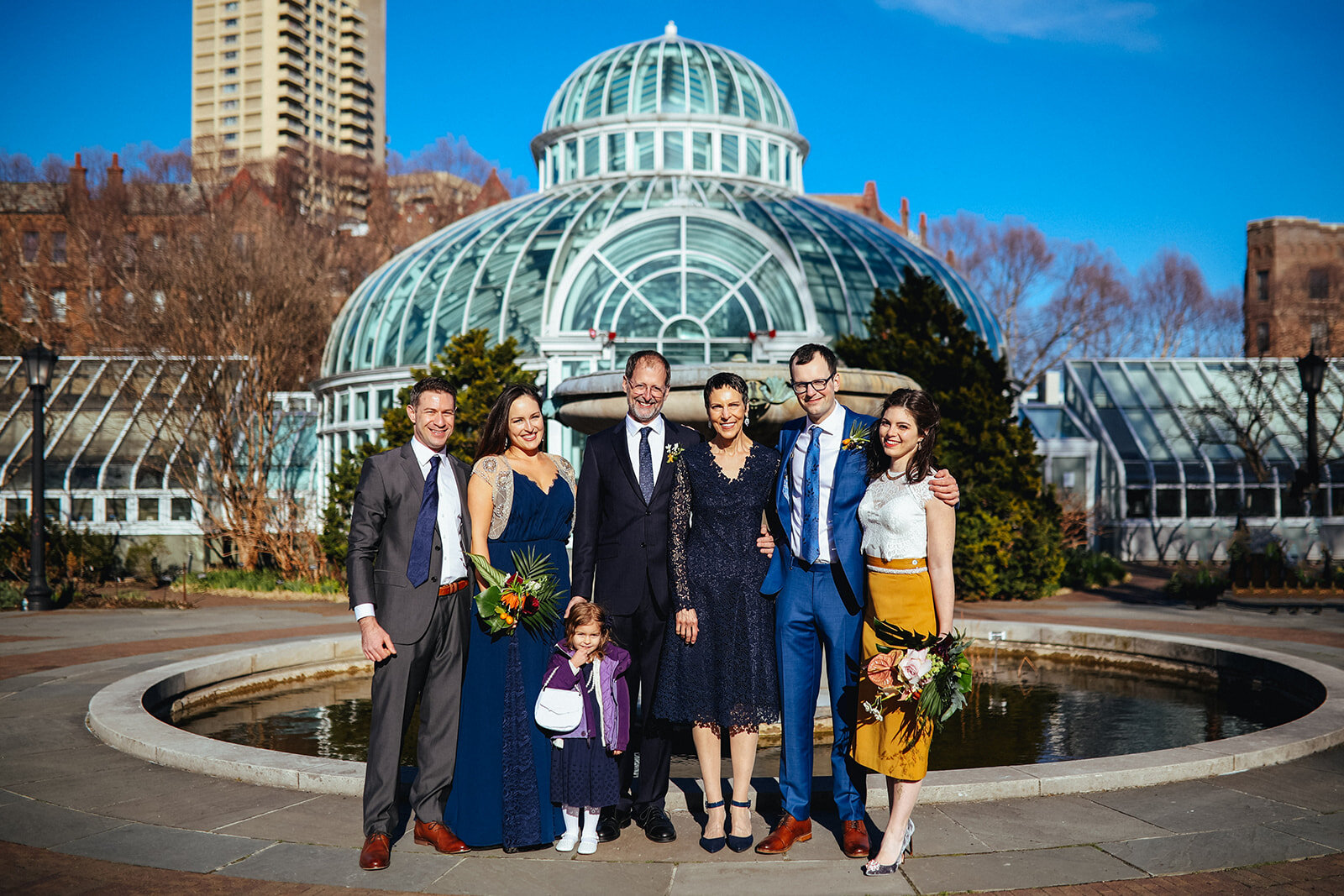 Bride and groom posing with family outside the Brooklyn Botanical Gardens Shawnee Custalow wedding photography