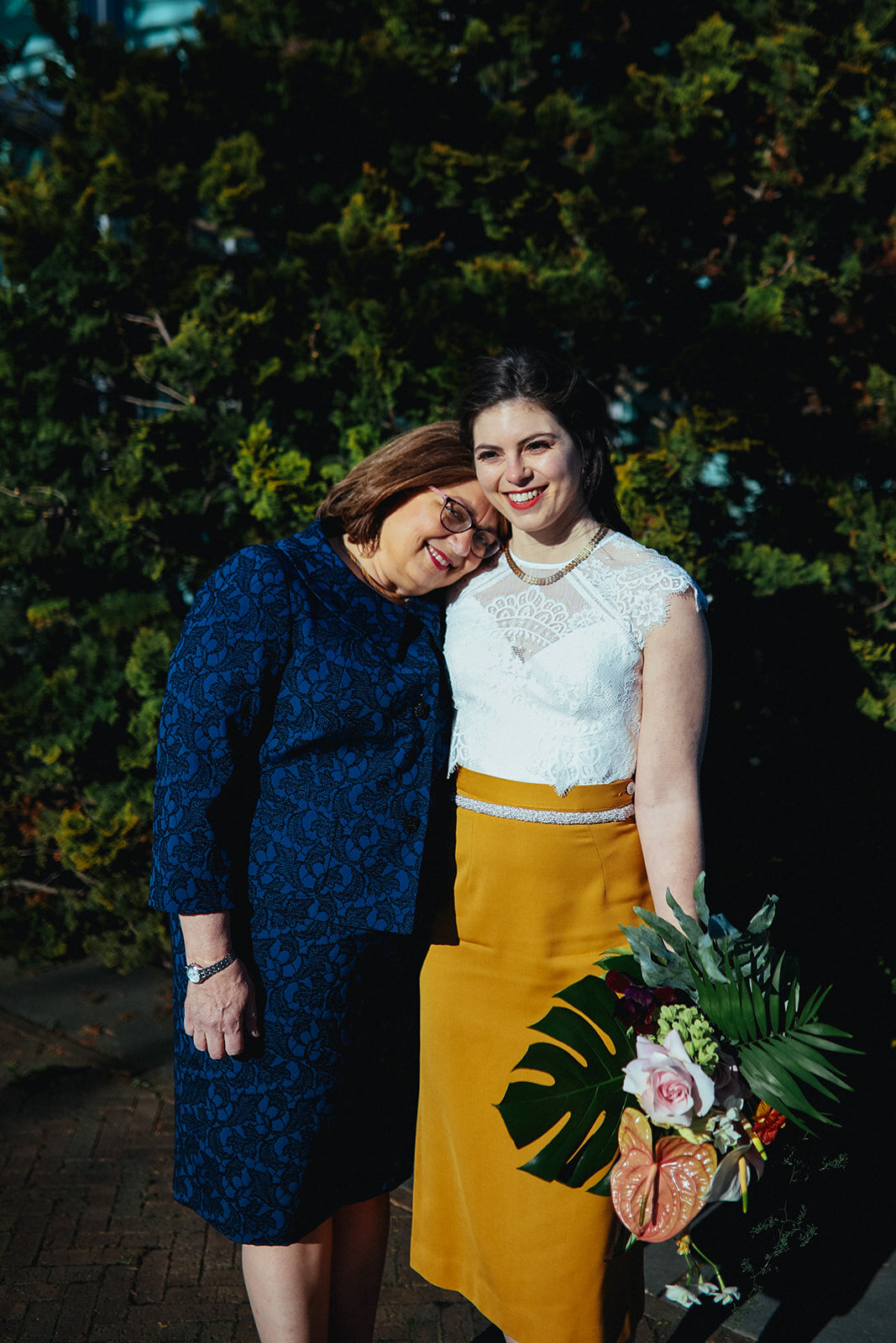 Bride posing with guest outside the Brooklyn Botanical Garden NY Shawnee Custalow wedding photography