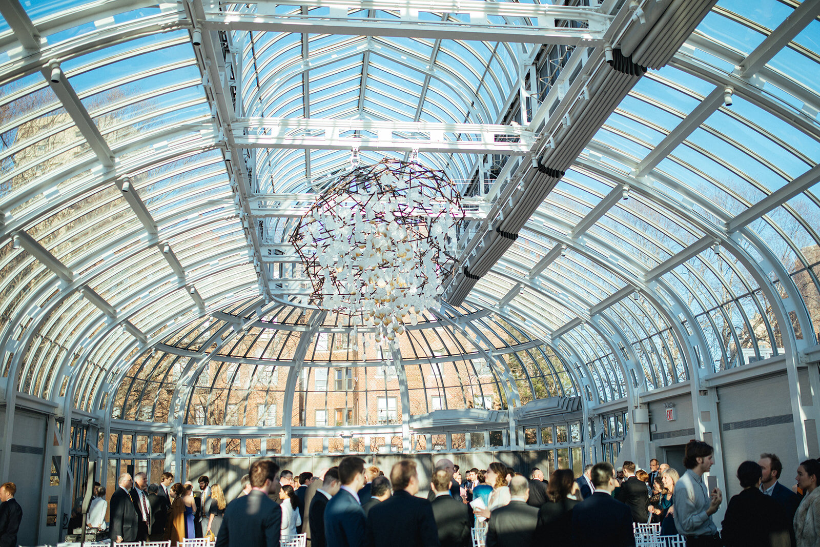 Large chandelier above wedding guests at the Brooklyn Botanical Garden Shawnee Custalow photography