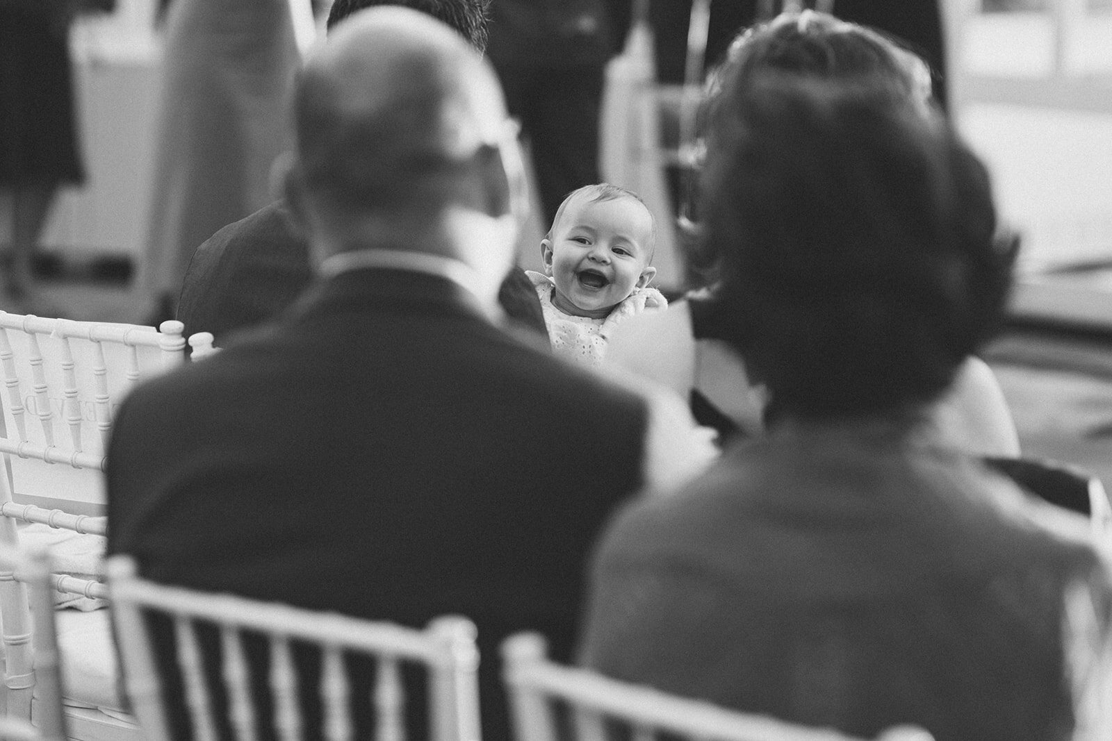 Happy baby at a wedding in the Brooklyn Botanical Garden Shawnee Custalow wedding photography