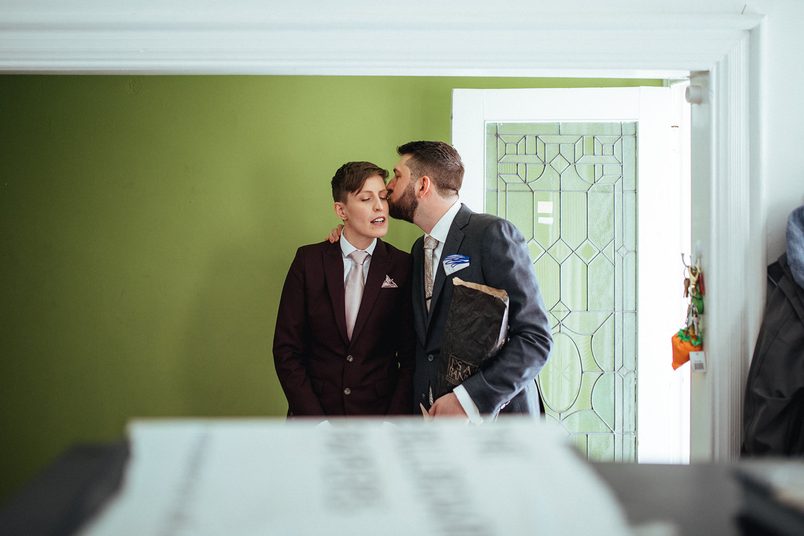 Fiance kissing his future spouse on the cheek at German Society of PA Shawnee Custalow LGBTQ wedding Photography