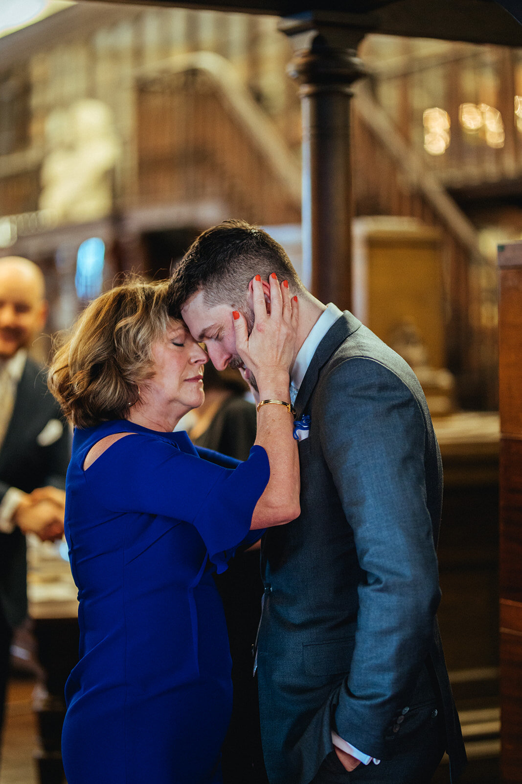 Newlywed spouse embraced by a guest at German Society of PA Shawnee Custalow wedding Photography