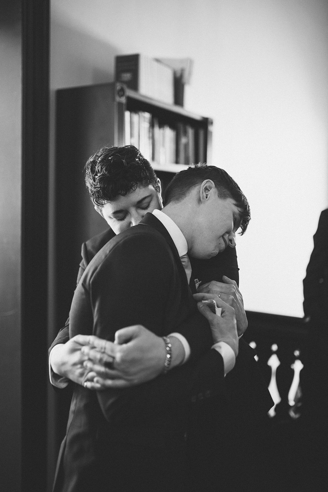 Newlywed spouse hugging a guest at German Society of PA Shawnee Custalow LGBTQ wedding Photography