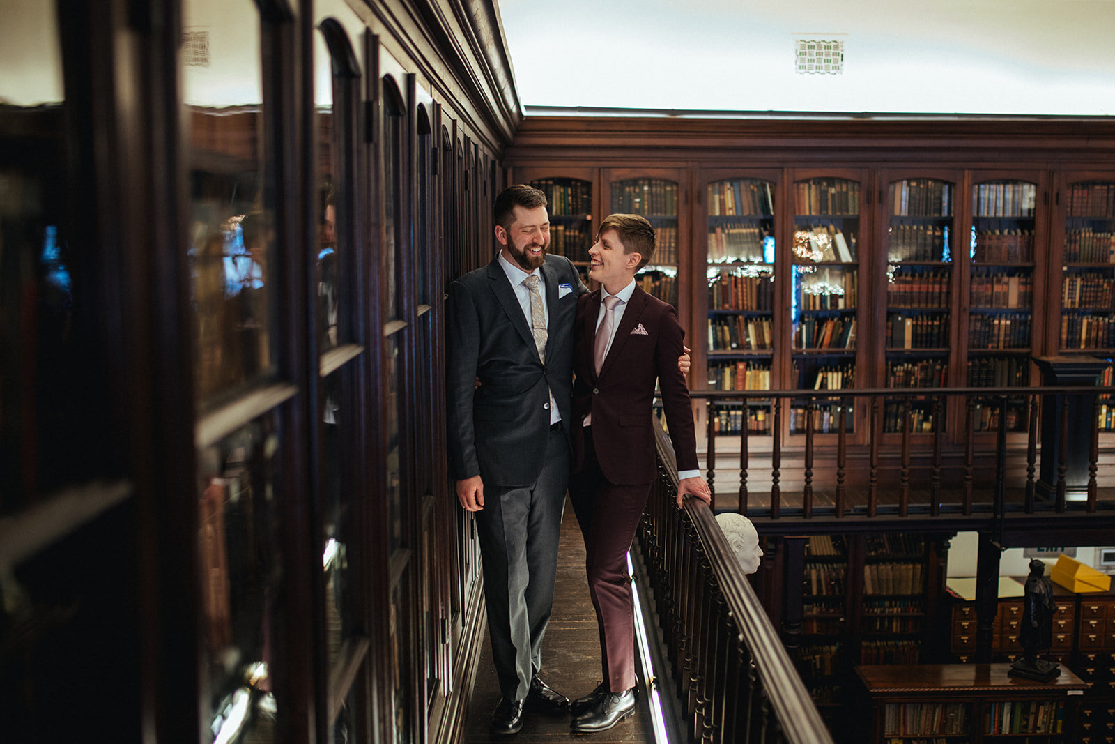 Happy newlyweds in library at German Society of PA Shawnee Custalow LGBTQ wedding Photography