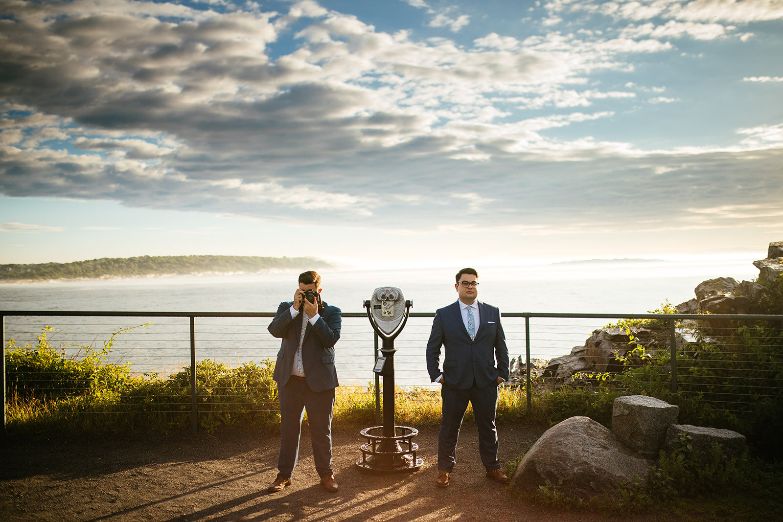 Queer couple posing with camera at a look out on Peaks Island Portland ME Shawnee Custalow wedding photography