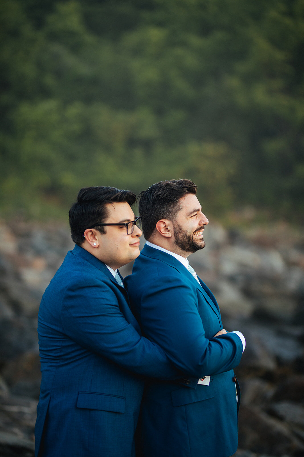 Future spouses embracing at sunrise on Peaks Island Portland ME Shawnee Custalow Queer wedding photography