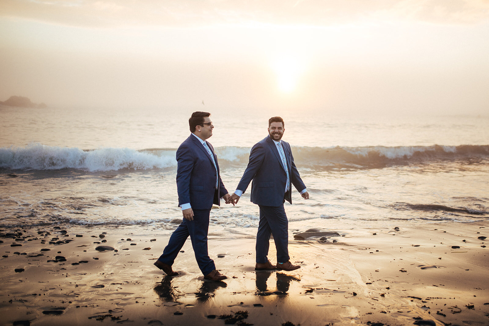 LGBTQ couple walking hand in hand on Peaks Island beach in Portland ME Shawnee Custalow wedding photography