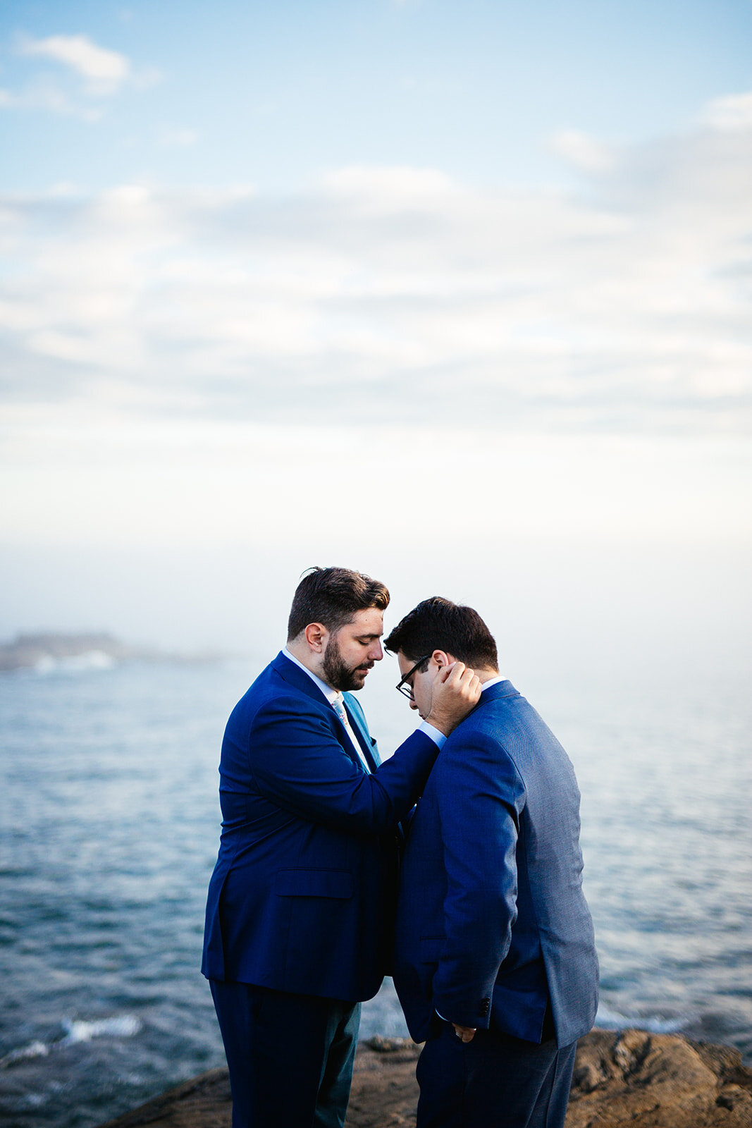 Same sex couple together by the ocean onPeaks Island Portland ME Shawnee Custalow wedding photography