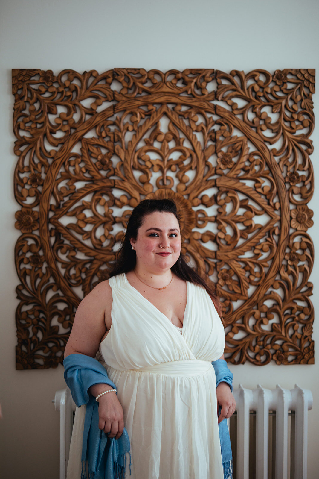 Honor attendant in a white dress with a blue shaw in Portland ME Shawnee Custalow Queer wedding photography