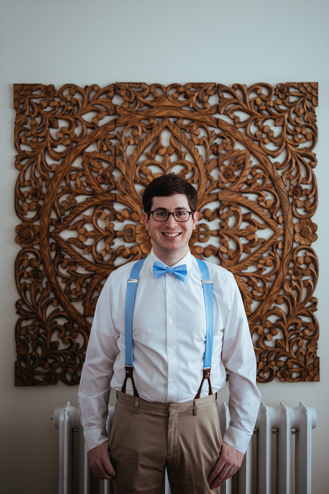 Honor attendant in blue bowtie and suspenders in Portland ME Shawnee Custalow Queer wedding photography