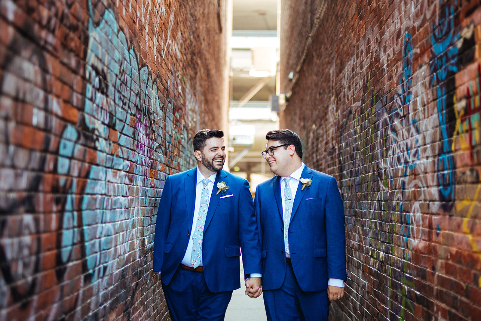 LGBTQ couple holding hands in an alley in Portland ME Shawnee Custalow Queer wedding photography