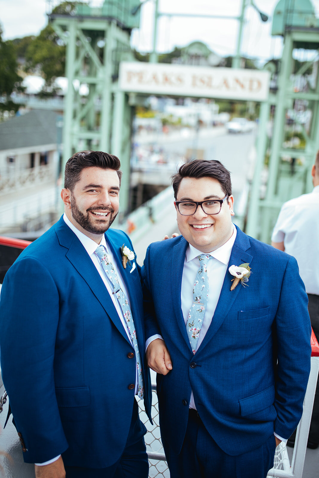 Two happy grooms on a ferry to Peaks Island Portland ME Shawnee Custalow Queer wedding photography