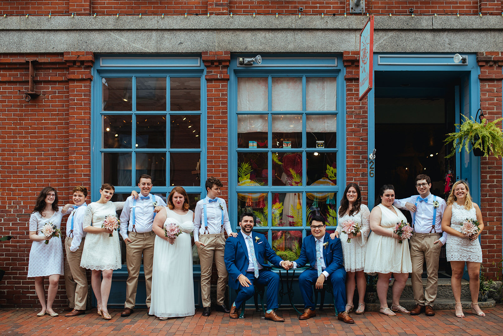 Two grooms posing with wedding party in Portland ME Shawnee Custalow Queer wedding photography