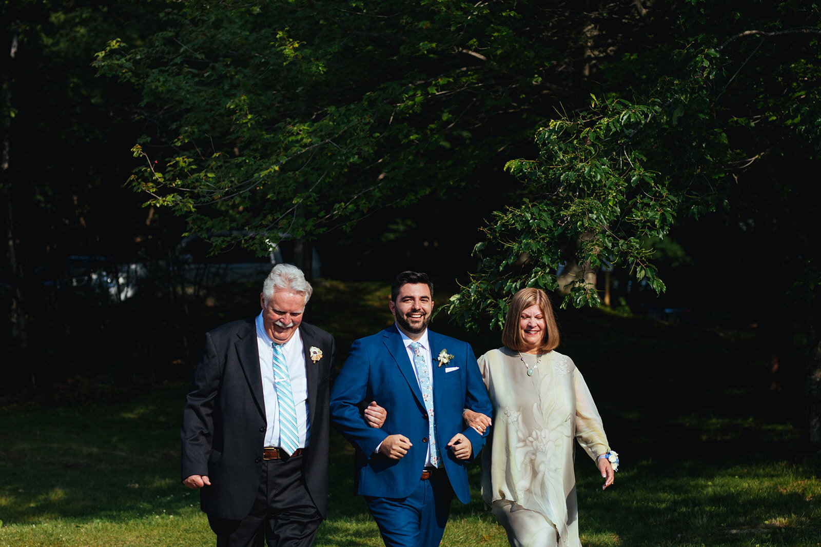 Groom escorted down the aisle by parents on Peaks Island Portland ME Shawnee Custalow wedding photography