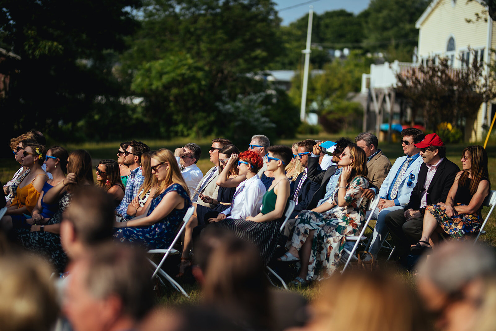 Wedding guests watching ceremony on Peaks Island Portland ME Shawnee Custalow Queer wedding photography