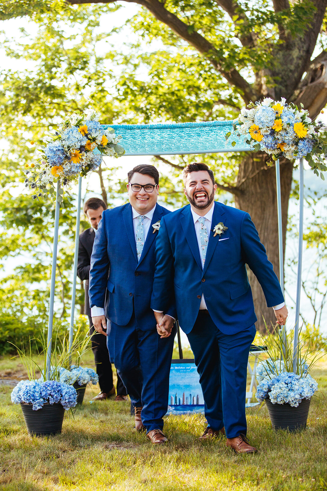 Happy newly married couple holding hands in Portland ME Shawnee Custalow Queer wedding photography