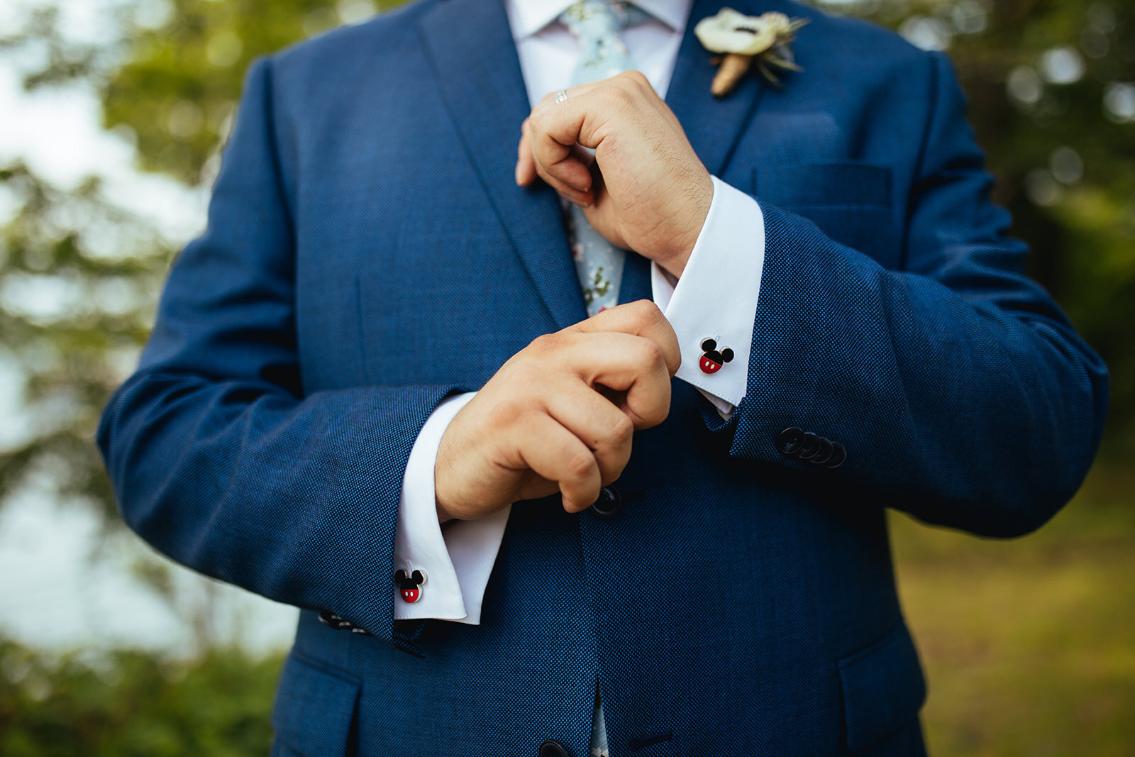 Groom with mickey mouse cufflinks in Portland ME Shawnee Custalow Queer wedding photography
