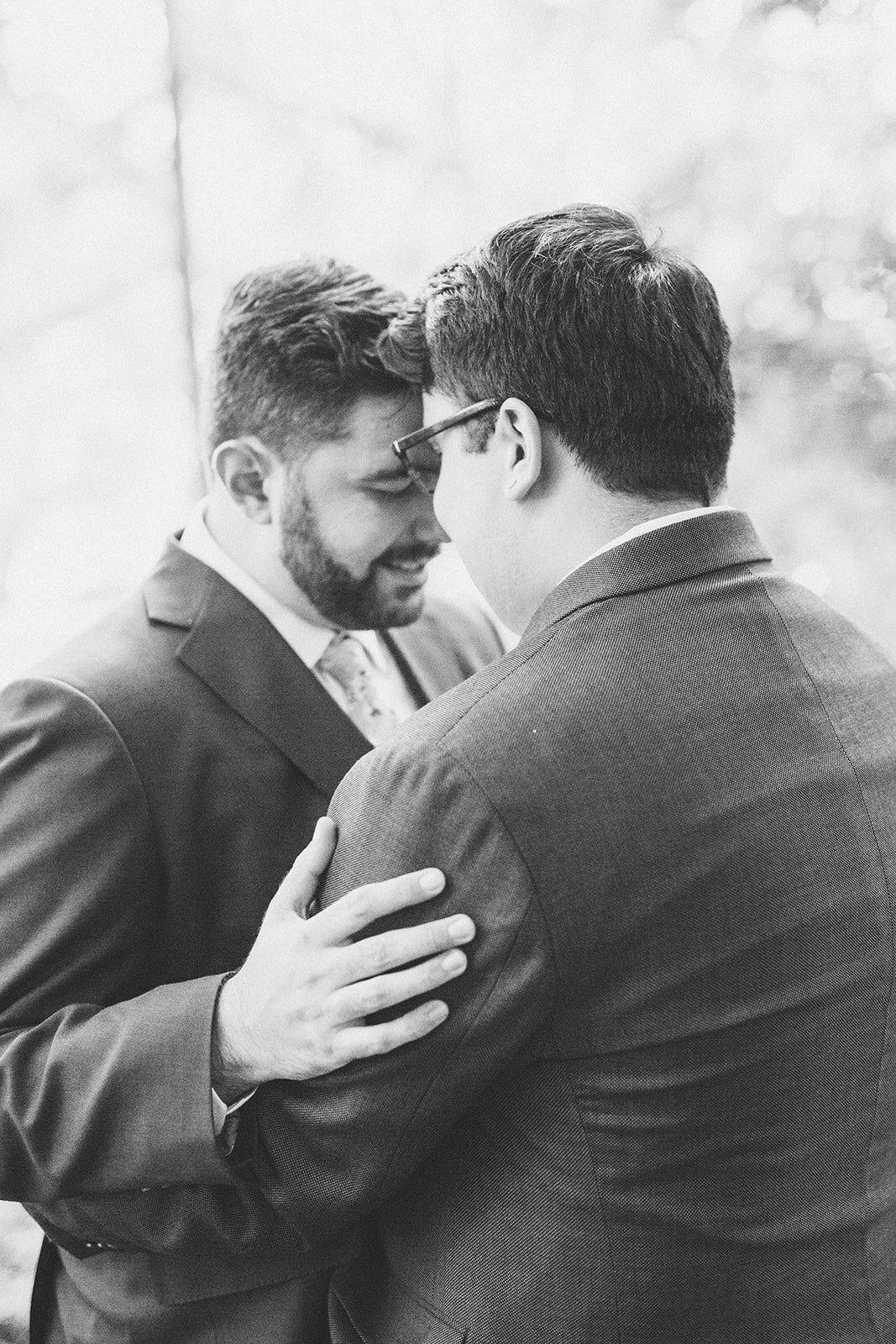 Newlyweds embracing in Portland ME Shawnee Custalow Queer wedding photography
