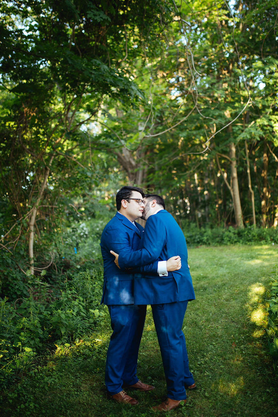 Newly married lgbtq couple embracing on peaks island Portland ME Shawnee Custalow wedding photography