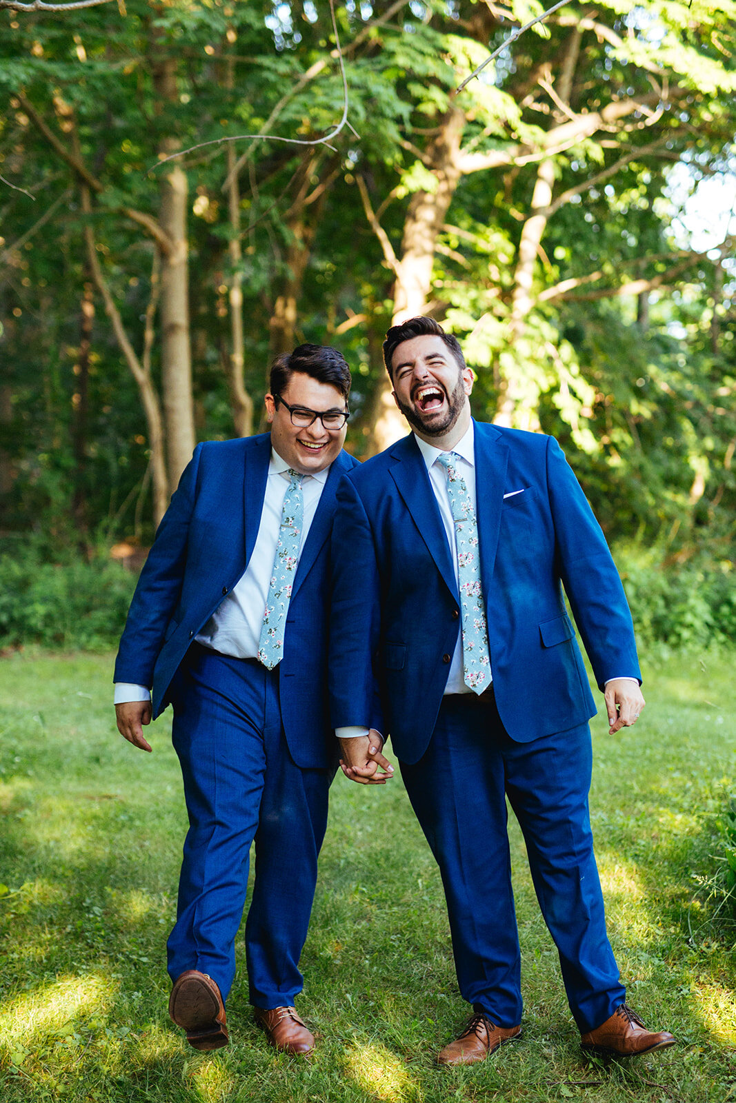 Happy newlyweds holding hands on peaks Island Portland ME Shawnee Custalow Queer wedding photography