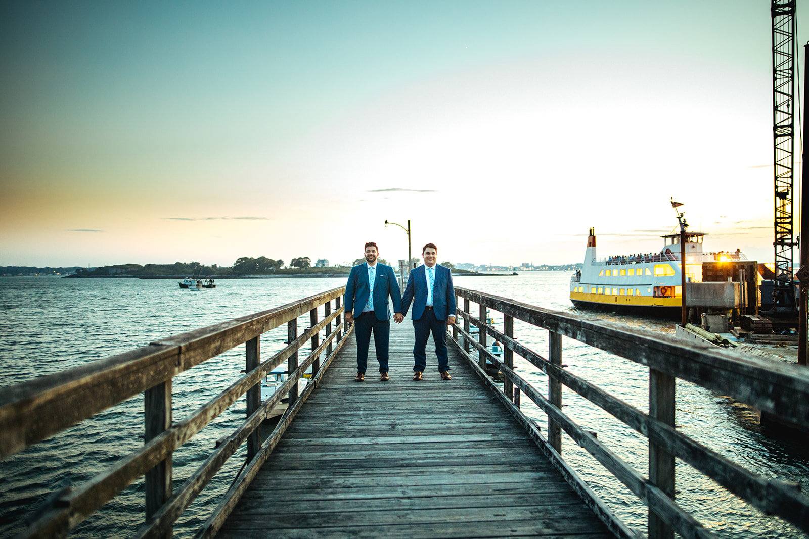 Newly married queer couple holding hands on a pier in Portland ME Shawnee Custalow wedding photography