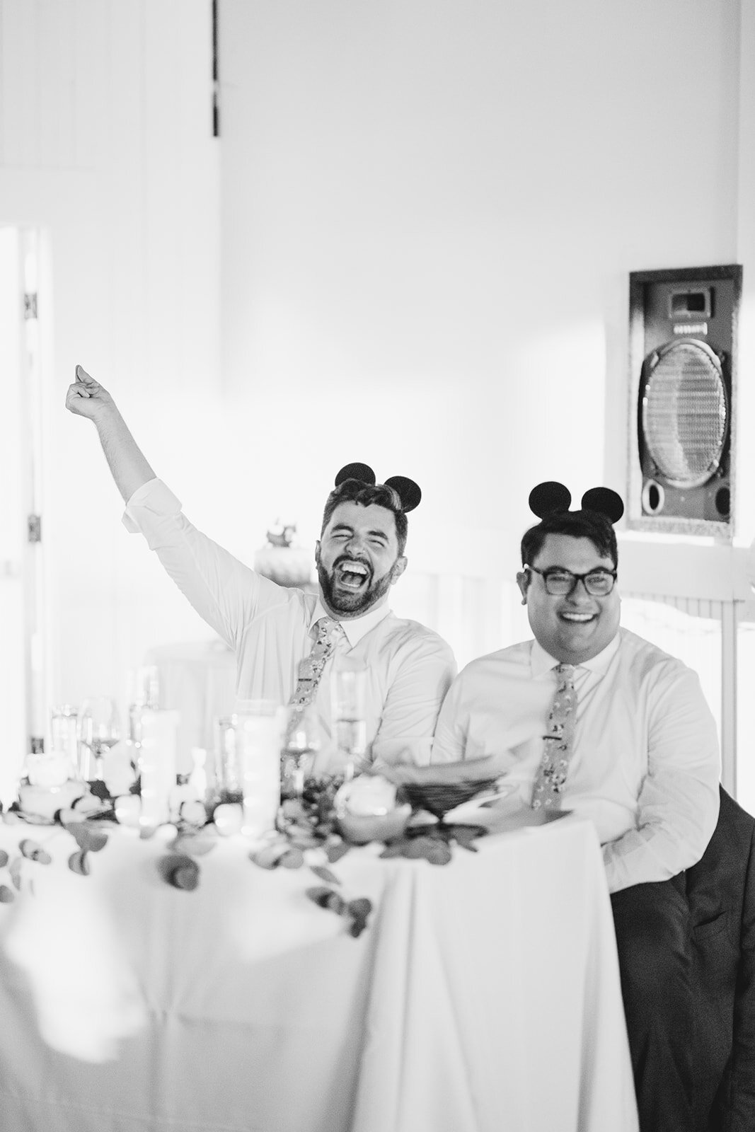 Newlyweds laughing in mickey mouse ears in Portland ME Shawnee Custalow Queer wedding photography
