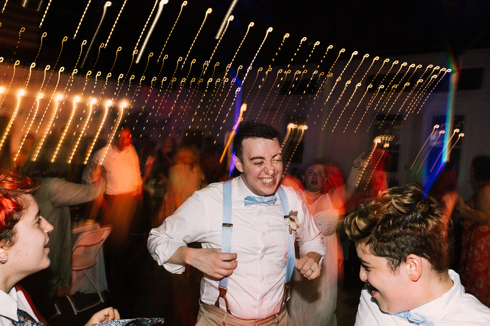 Honor attendant dancing at reception in Portland ME Shawnee Custalow Queer wedding photography