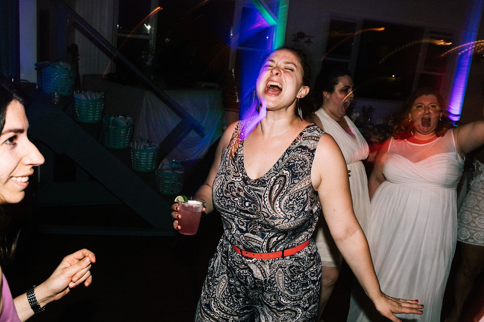 Wedding guest dancing and singing in Portland ME Shawnee Custalow Queer wedding photography