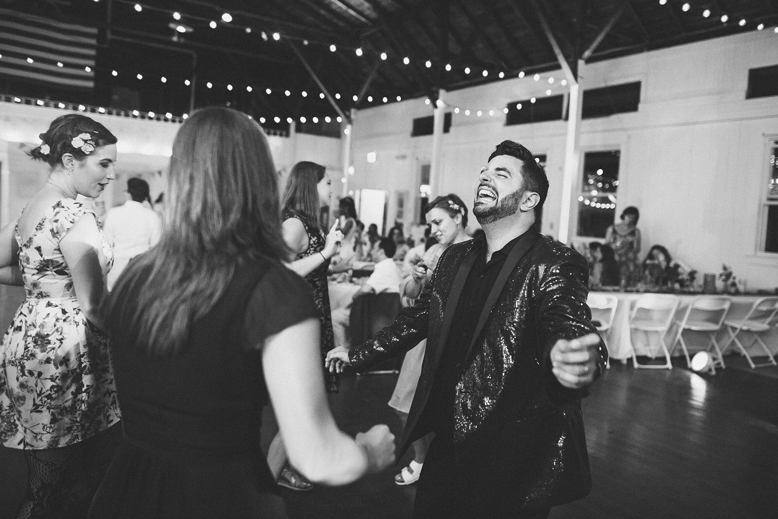 Newlywed dancing with guests in Portland ME Shawnee Custalow Queer wedding photography