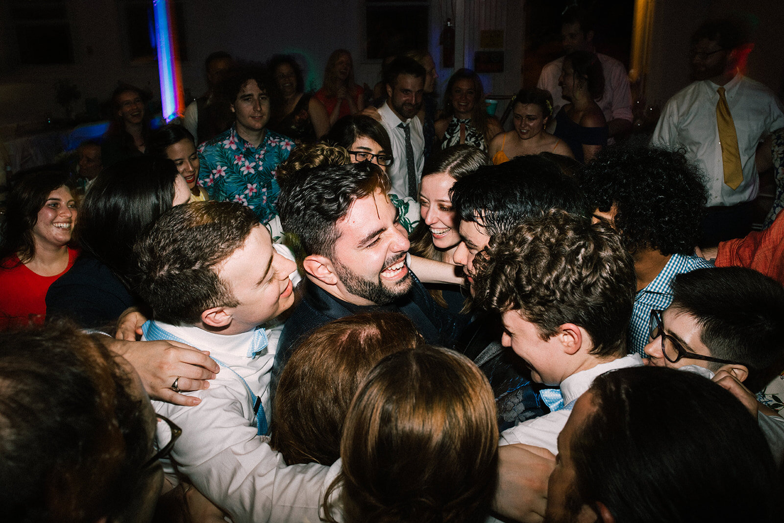 Wedding guests and newlyweds hugging in Portland ME Shawnee Custalow Queer wedding photography
